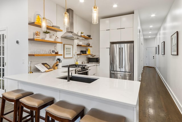 kitchen with open shelves, appliances with stainless steel finishes, wall chimney exhaust hood, decorative backsplash, and dark wood-type flooring