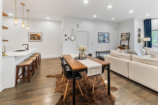 dining area featuring dark wood-type flooring and recessed lighting