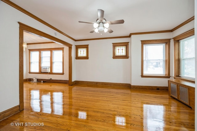 1521 Cuyler Ave, Berwyn, IL 60402 - spare room featuring crown molding, radiator heating unit, wood finished floors, baseboards, and a ceiling fan