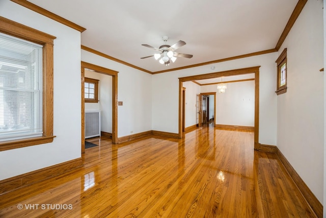 1521 Cuyler Ave, Berwyn, IL 60402 - spare room featuring light wood-style flooring, baseboards, ceiling fan, ornamental molding, and radiator
