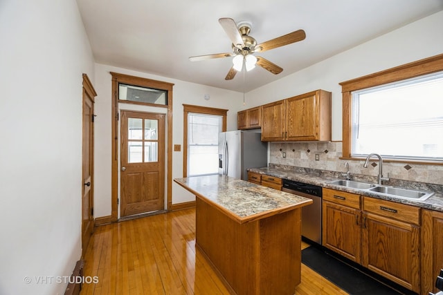 1521 Cuyler Ave, Berwyn, IL 60402 - kitchen with a sink, stainless steel appliances, brown cabinets, and a center island