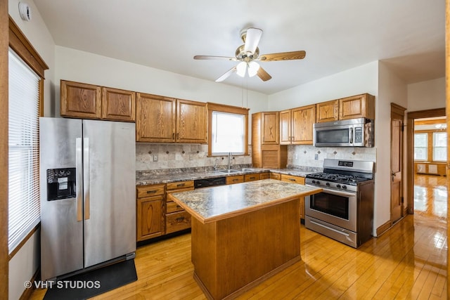 1521 Cuyler Ave, Berwyn, IL 60402 - kitchen featuring appliances with stainless steel finishes, light wood-style flooring, a sink, a center island, and ceiling fan