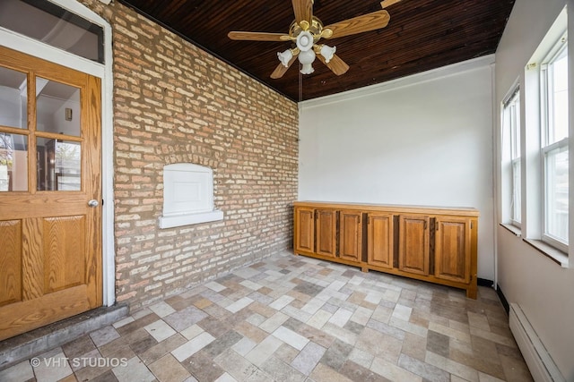 1521 Cuyler Ave, Berwyn, IL 60402 - empty room featuring a baseboard heating unit, brick wall, wooden ceiling, ceiling fan, and light stone finish floors