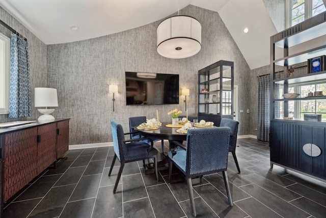 dining space featuring recessed lighting, high vaulted ceiling, baseboards, and dark tile patterned floors
