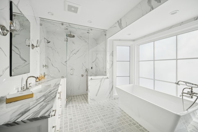 bathroom with vanity, a soaking tub, a marble finish shower, and visible vents