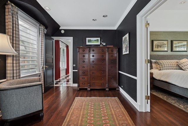 interior space featuring baseboards, ornamental molding, and wood finished floors
