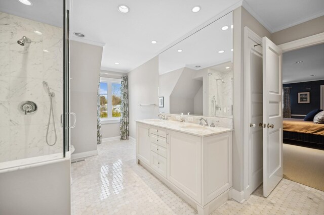 ensuite bathroom featuring a sink, ornamental molding, a marble finish shower, and connected bathroom