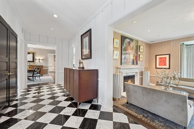 corridor with crown molding, a decorative wall, and recessed lighting