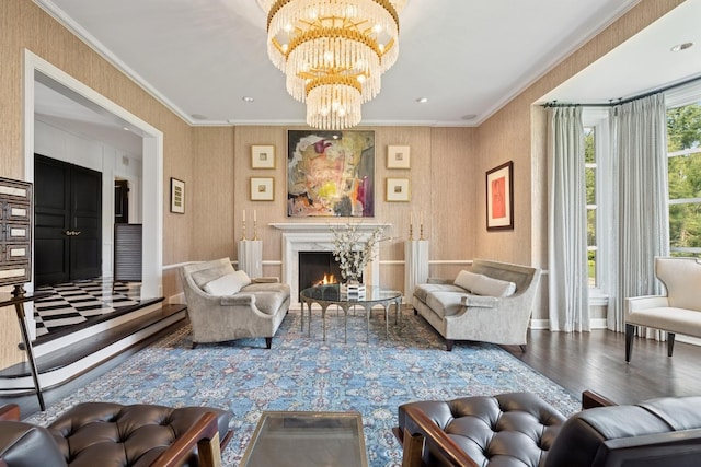 living room featuring crown molding, wood finished floors, baseboards, an inviting chandelier, and a premium fireplace