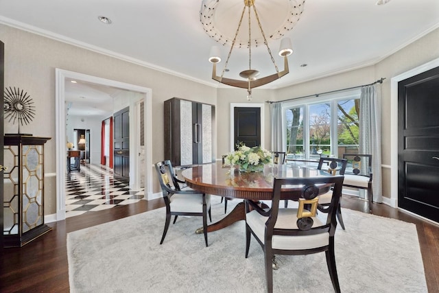 dining space with baseboards, ornamental molding, and wood finished floors