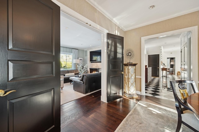 interior space featuring baseboards, ornamental molding, and wood finished floors