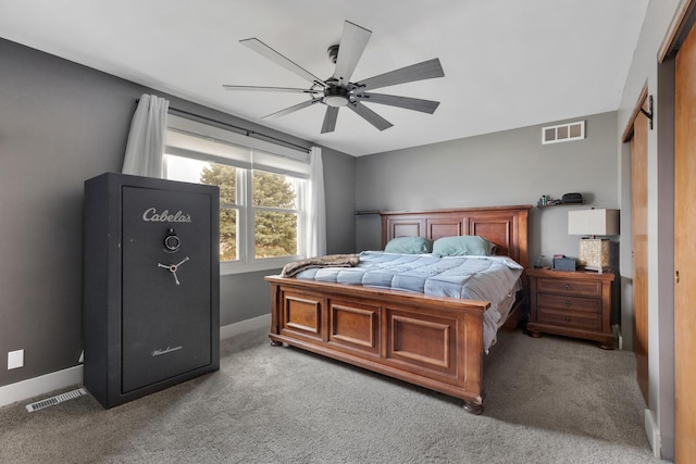 carpeted bedroom with baseboards, a ceiling fan, and visible vents