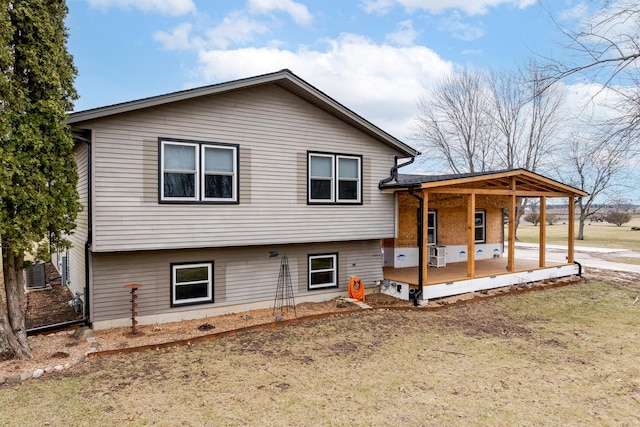 back of property featuring covered porch and a carport