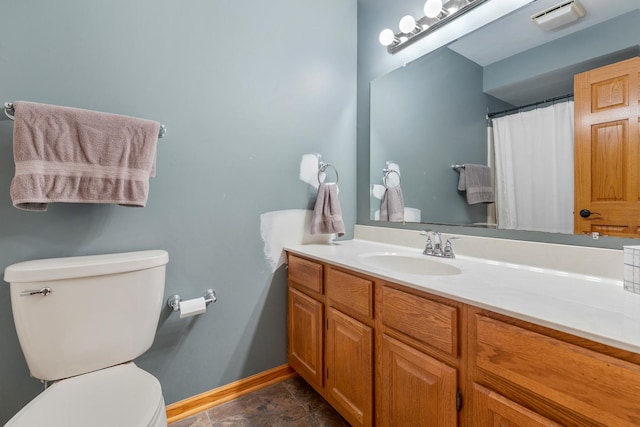 bathroom featuring toilet, baseboards, visible vents, and vanity