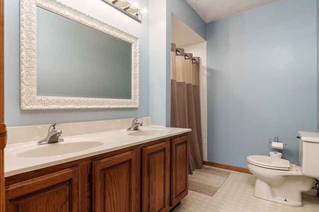 full bathroom featuring a sink, tile patterned floors, a shower with curtain, and toilet