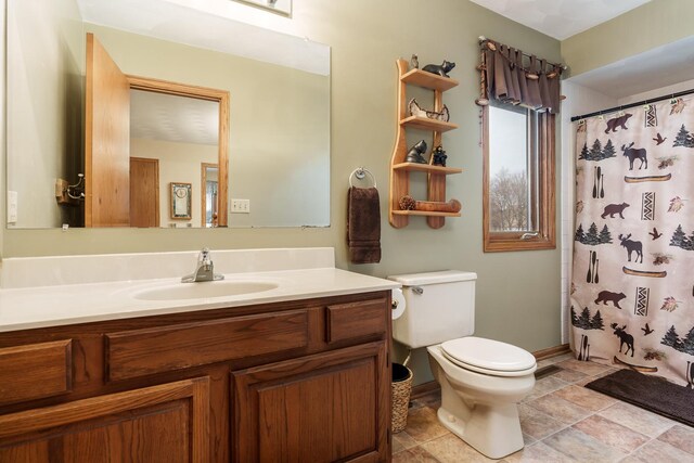 bathroom featuring vanity, baseboards, a shower with curtain, and toilet