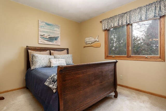 bedroom with carpet flooring and baseboards