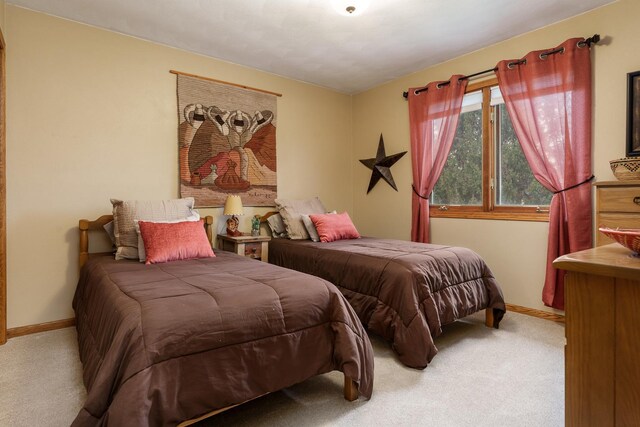 bedroom featuring carpet floors and baseboards