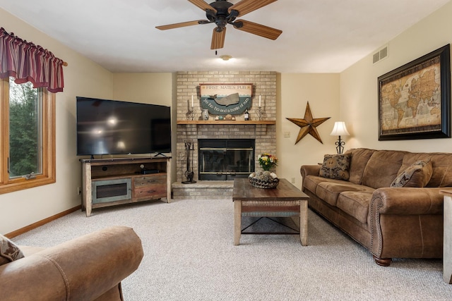 carpeted living area featuring visible vents, a ceiling fan, baseboards, and a fireplace