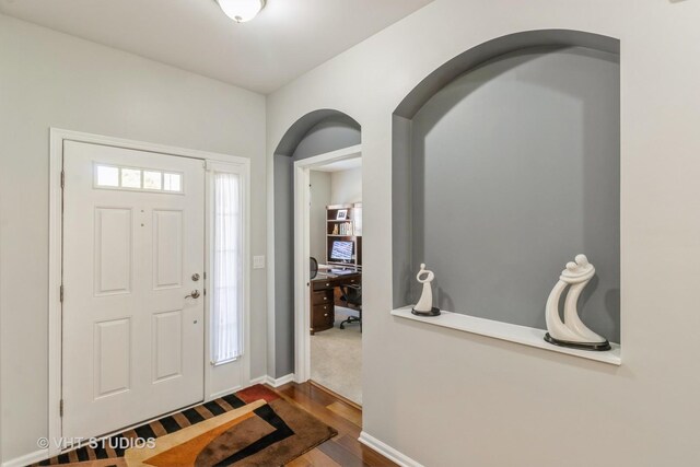 1674 Francis Dr, Pingree Grove, IL 60140 - entrance foyer featuring arched walkways, wood finished floors, and baseboards