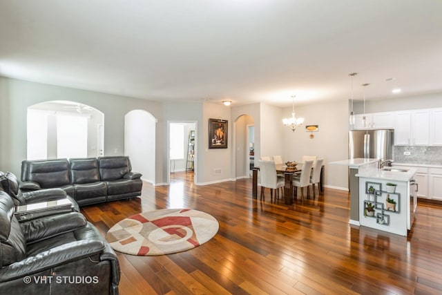1674 Francis Dr, Pingree Grove, IL 60140 - living area featuring arched walkways, dark wood finished floors, a chandelier, recessed lighting, and baseboards