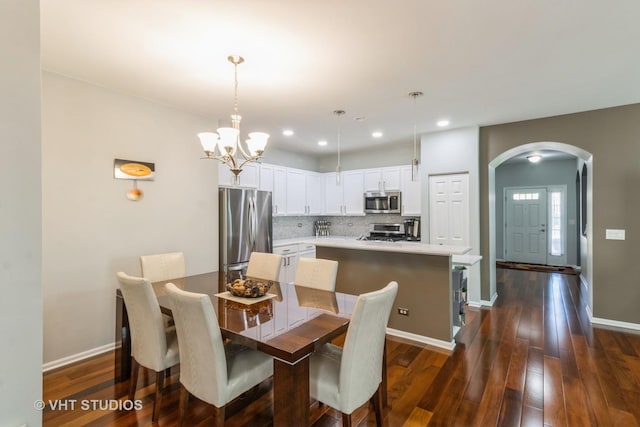 1674 Francis Dr, Pingree Grove, IL 60140 - dining space with arched walkways, dark wood finished floors, a chandelier, baseboards, and recessed lighting