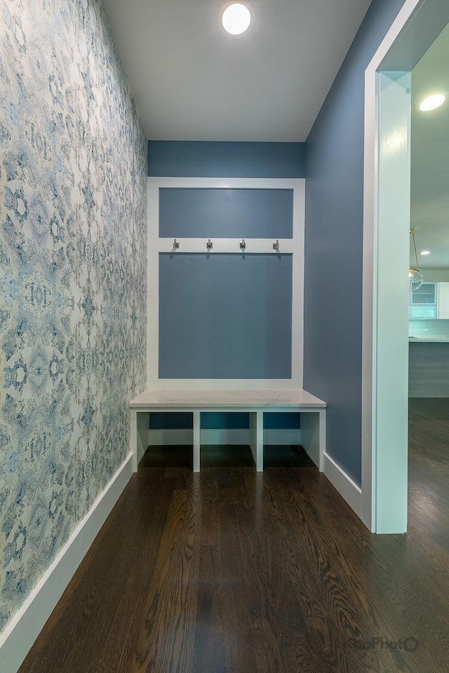mudroom featuring baseboards, an accent wall, wallpapered walls, and wood finished floors