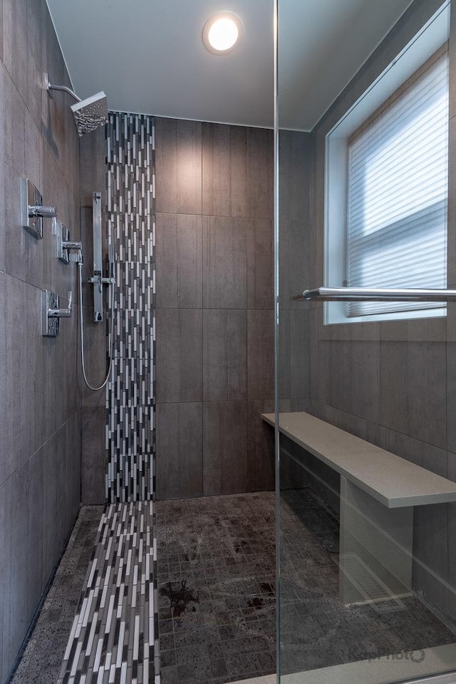 full bath with a tile shower