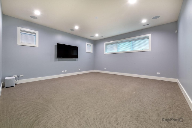 unfurnished room with dark carpet, recessed lighting, baseboards, and visible vents