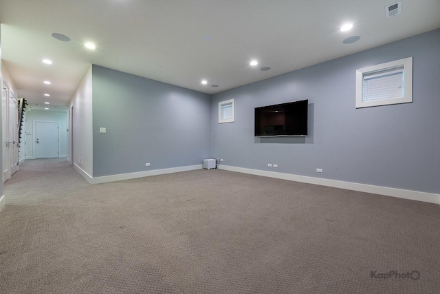 basement with baseboards, carpet, recessed lighting, and visible vents