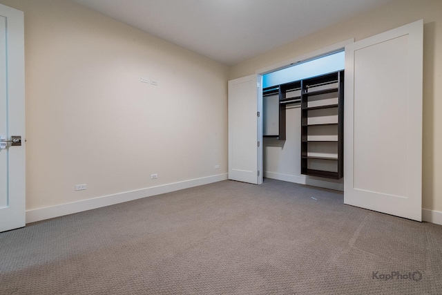 unfurnished bedroom with carpet floors and baseboards