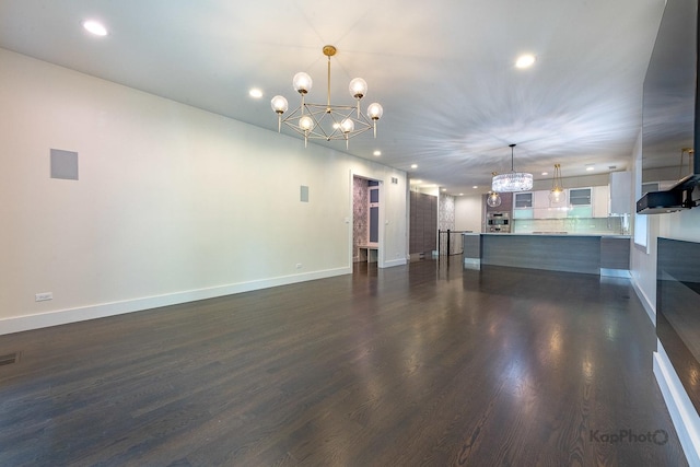 interior space featuring recessed lighting, dark wood-style flooring, and a chandelier