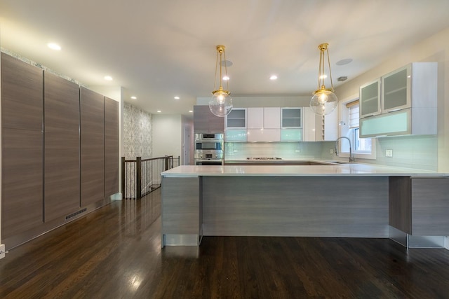 kitchen with visible vents, light countertops, modern cabinets, and dark wood-type flooring
