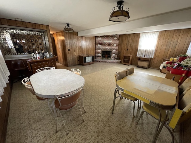 7236 W Olive Ave, Chicago, IL 60631 - dining room featuring a brick fireplace and wood walls