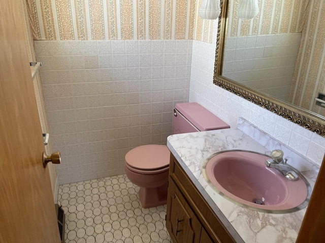7236 W Olive Ave, Chicago, IL 60631 - bathroom featuring tile walls, wallpapered walls, vanity, and toilet