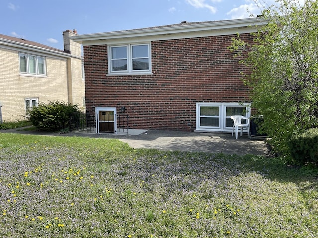 7236 W Olive Ave, Chicago, IL 60631 - back of property featuring a lawn, brick siding, and a patio