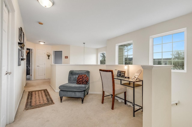 sitting room featuring baseboards, light carpet, and an upstairs landing