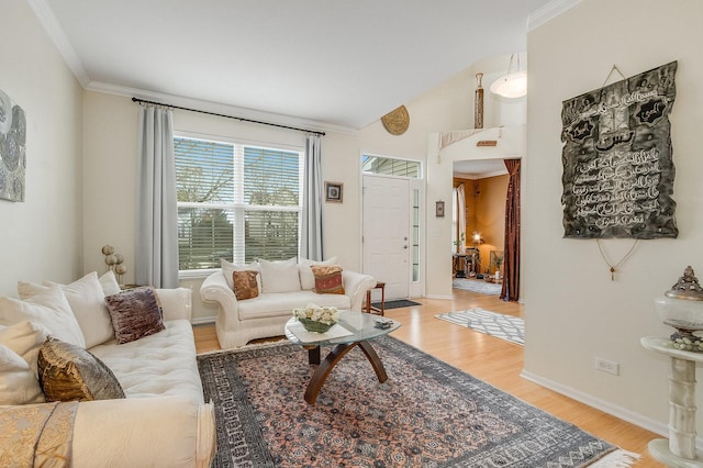 living area with light wood-type flooring, baseboards, and crown molding