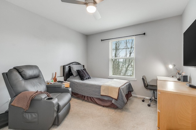 bedroom with baseboards, a ceiling fan, and light carpet
