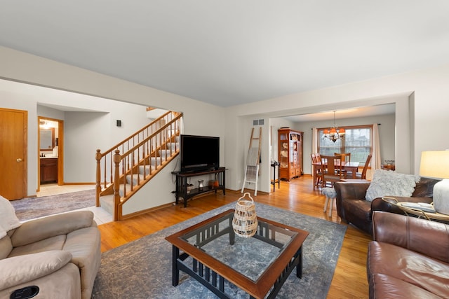 2739 Genoa Dr, New Lenox, IL 60451 - living room with stairway, a chandelier, and light wood finished floors