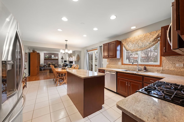 2739 Genoa Dr, New Lenox, IL 60451 - kitchen with appliances with stainless steel finishes, a sink, a chandelier, backsplash, and a center island