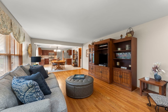 2739 Genoa Dr, New Lenox, IL 60451 - living room featuring a chandelier and light wood-type flooring