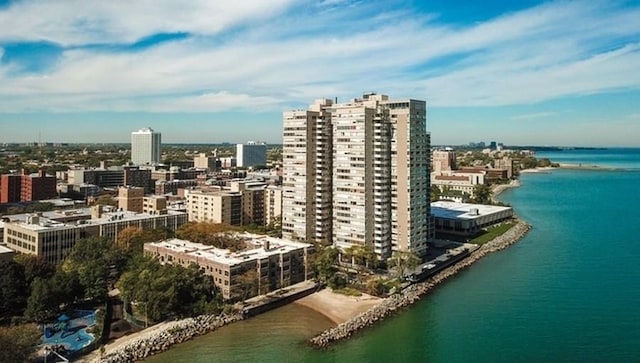 drone / aerial view featuring a view of city and a water view