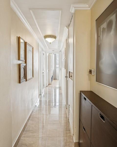 corridor with crown molding and a tray ceiling