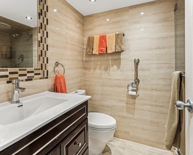 full bathroom with tile walls, vanity, toilet, recessed lighting, and tiled shower