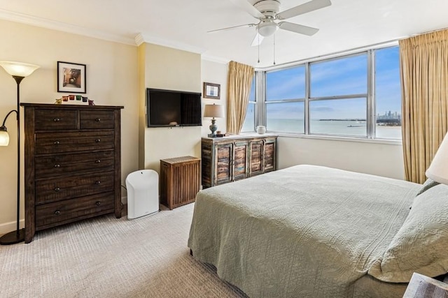 bedroom with ornamental molding, a ceiling fan, and carpet flooring