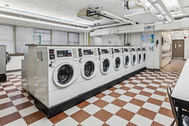 common laundry area featuring tile patterned floors, washer and clothes dryer, and stacked washer and clothes dryer