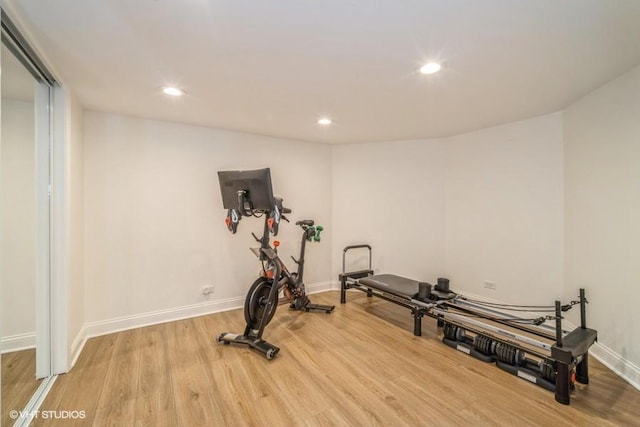 exercise room featuring wood finished floors, baseboards, and recessed lighting