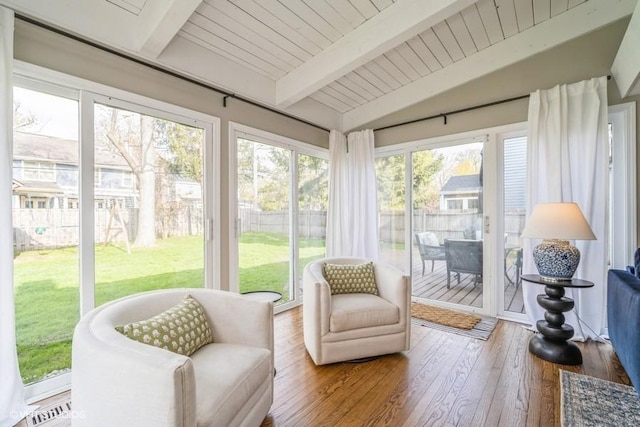 sunroom / solarium featuring beam ceiling