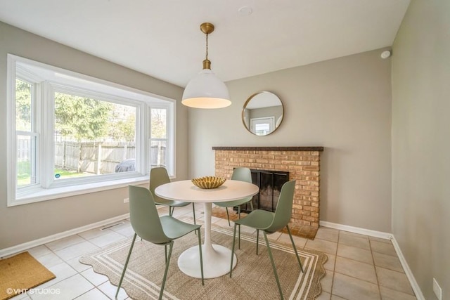 dining space with light tile patterned floors, visible vents, and baseboards